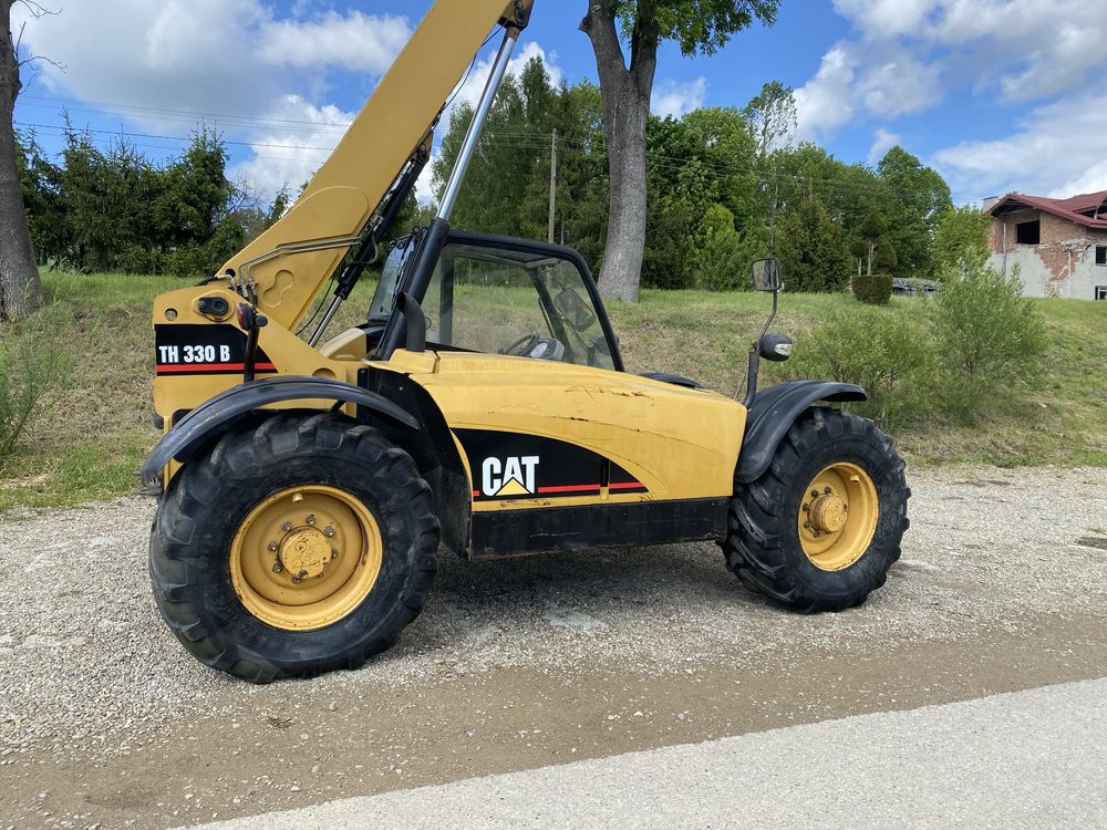 Cat TH 330 spr z Francji  7m 2004r