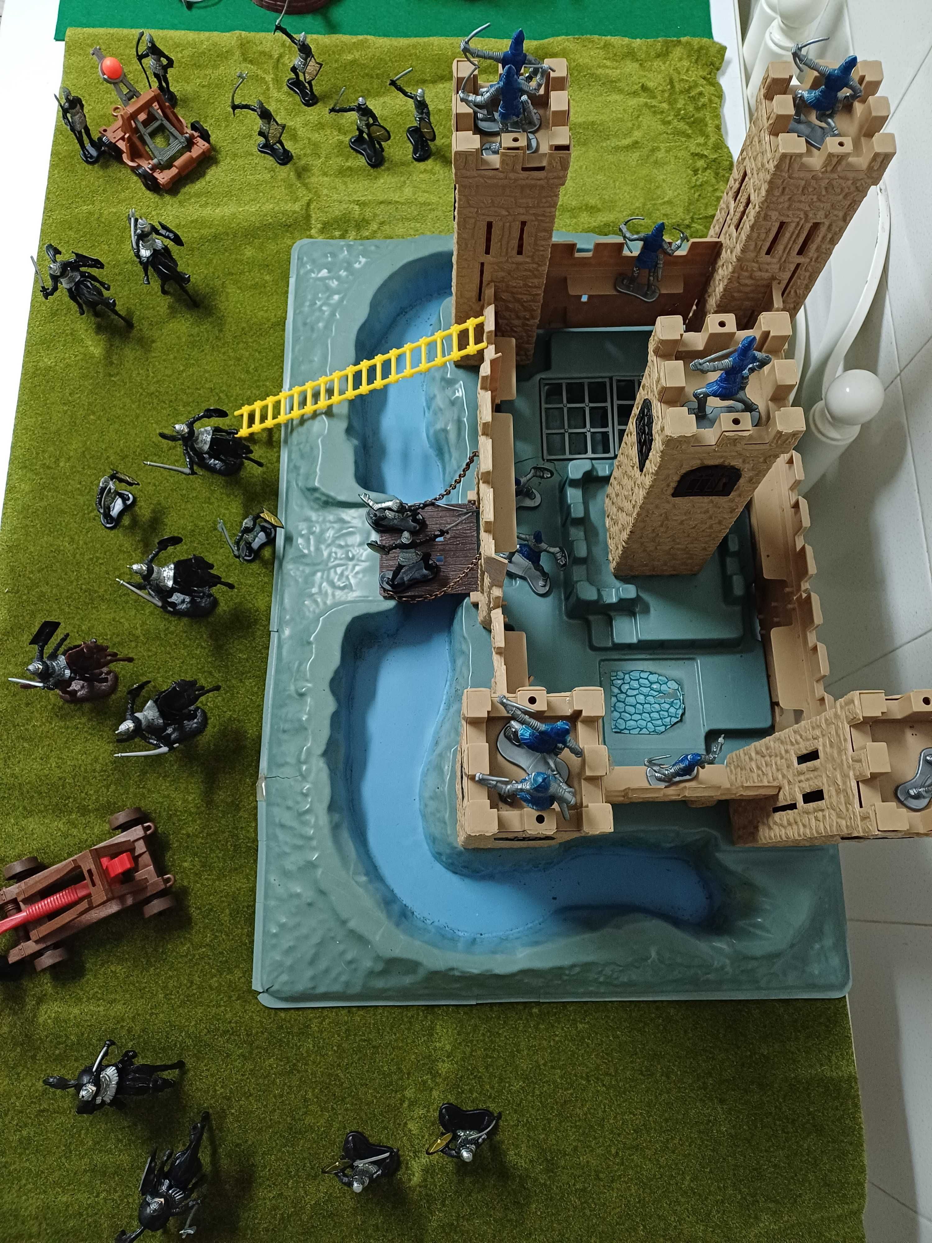 Castelo medieval com exércitos e catapultas