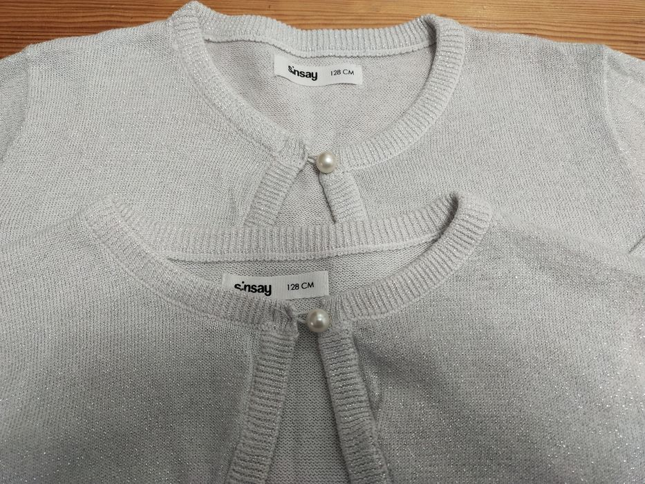 Dwa śliczne bolerka Sinsay 128 brokatowe srebrne