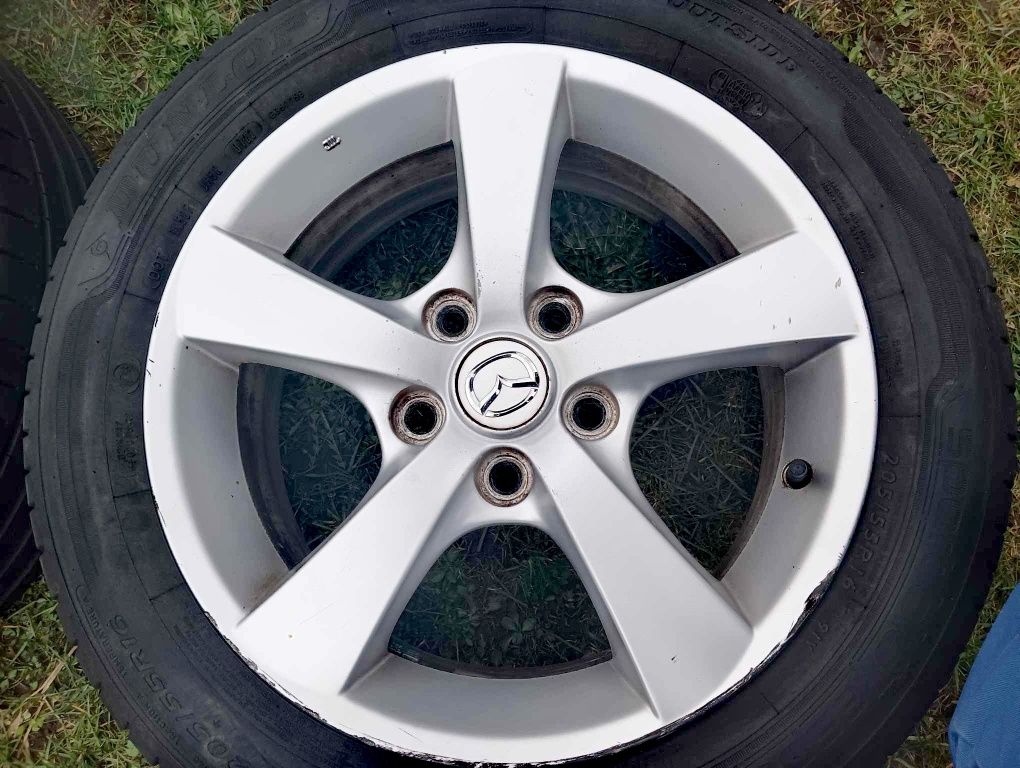 Oryginalne felgi aluminiowe mazda 16" z 2 letnimi oponami DUNLOP