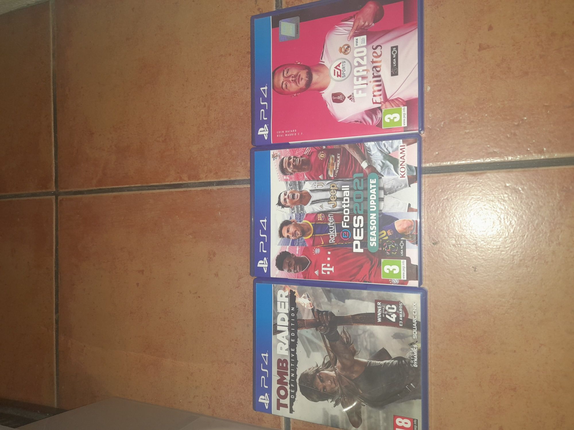 PS4 com dois comandos mais pes 21, FIFA 20 e tomb raider