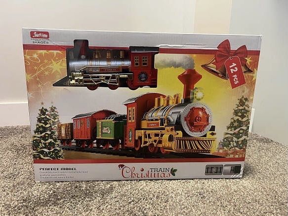 Дитяча різдвяна залізниця поїзд що світиться та гуде святкова іграшка