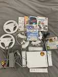 Nintendo Wii + comandos + volantes + jogos
