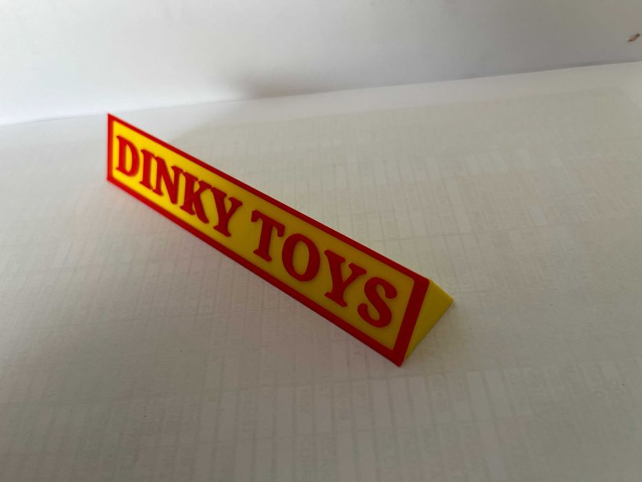 Sinal DINKY TOYS p/expositor miniaturas, paral. triang.reg., amarelo