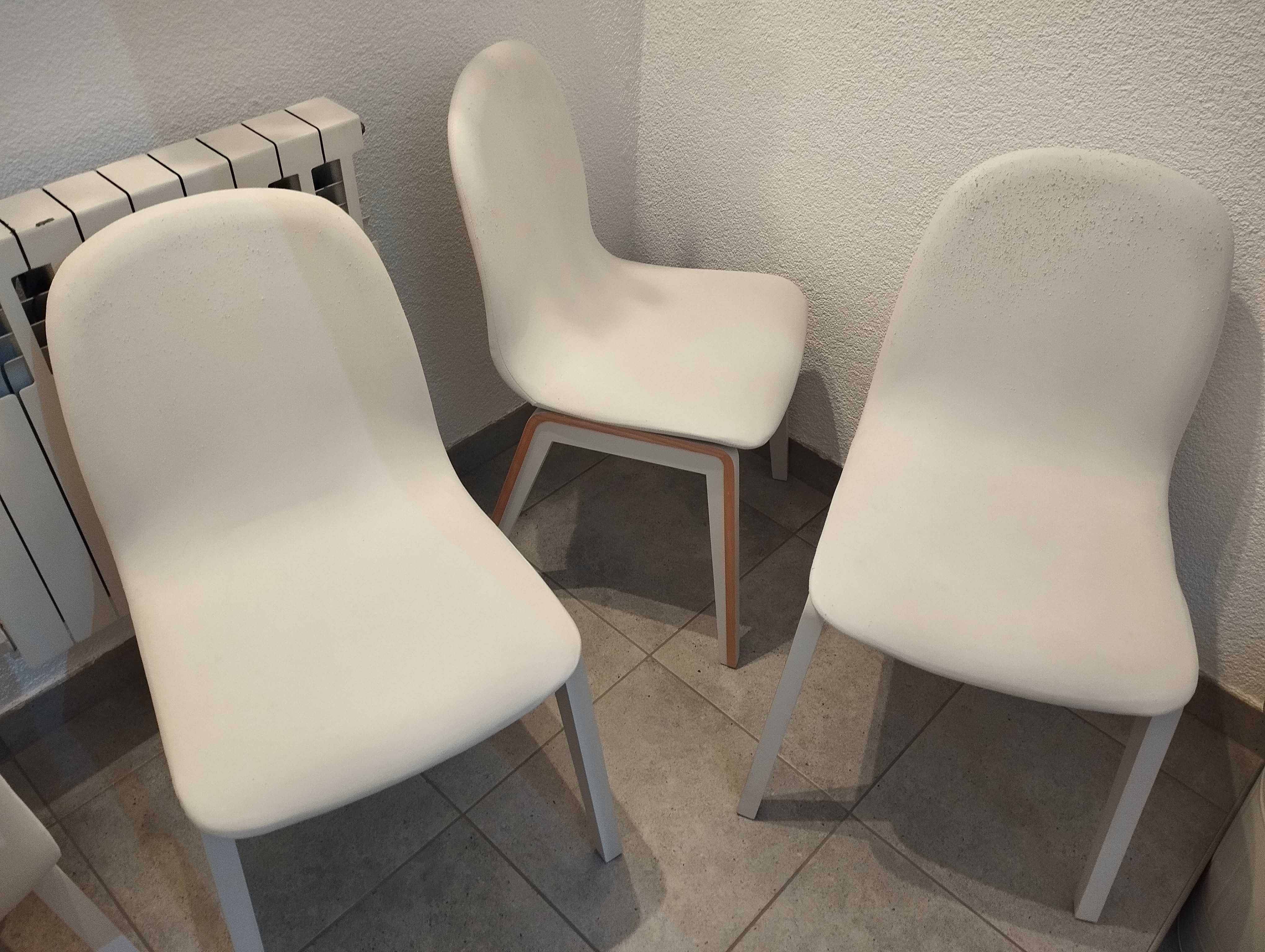 Cztery białe krzesła
