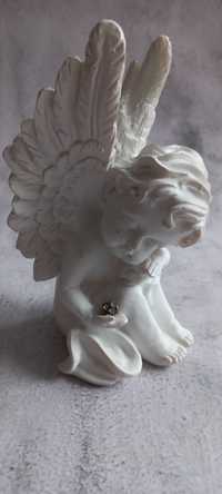 Figurka siedzący aniołek z kulą