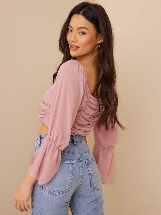 Рожевий топ з об'ємними рукавами