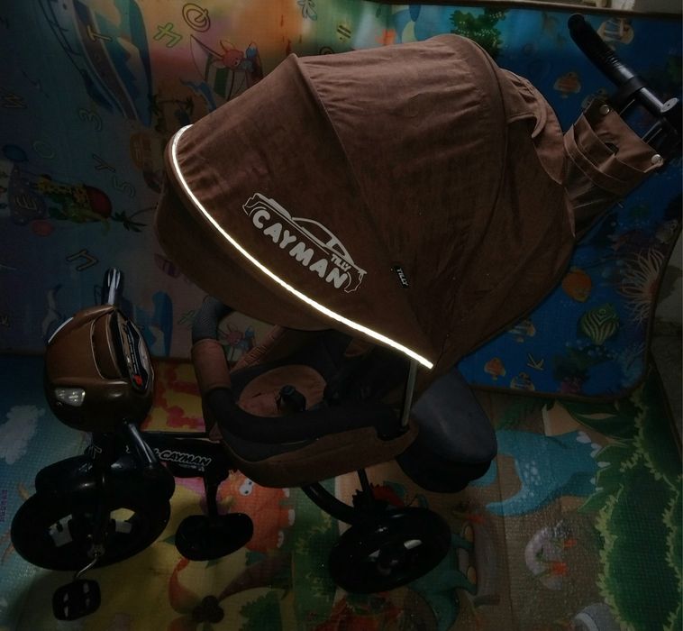 Продам детский музыкальный  велосипед-коляска Cayman.