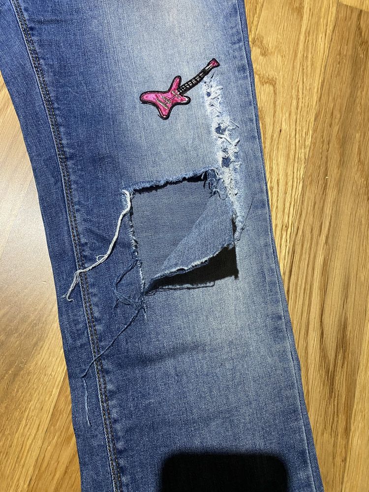 Spodnie jeansy z przetarciami roz 42