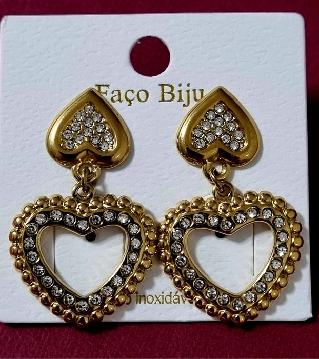 Brincos dourados, em aço, 2 corações invertidos com zirconias. De pico