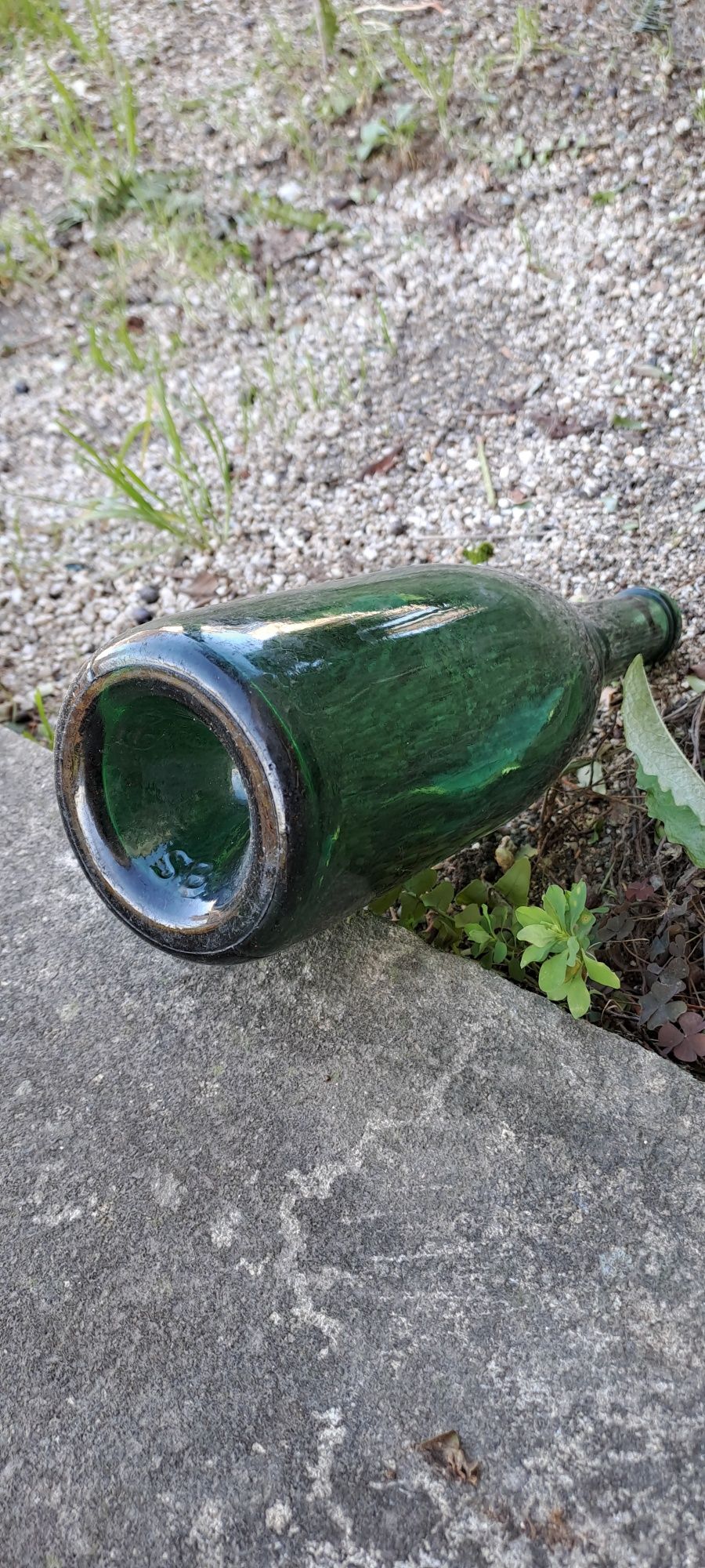 Garrafas de vidro verde e garrafeiras de barro