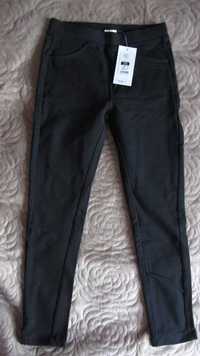 Długie czarne legginsy jegginsy spodnie z kieszeniami r 140 NOWE metka
