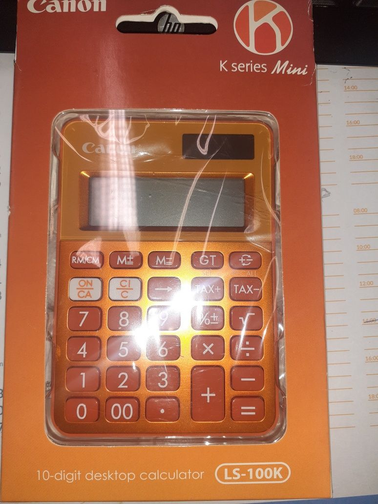 Máquina calculadora laranja da Canon.