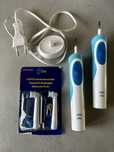 Dwie szczoteczki eletryczne Oral B z nowymi końcówkami i ładowarka