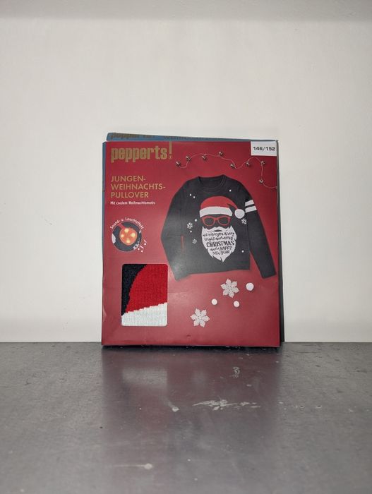 Świąteczny sweter chłopięcy z mikołajem niebieski Pepperts 146/152