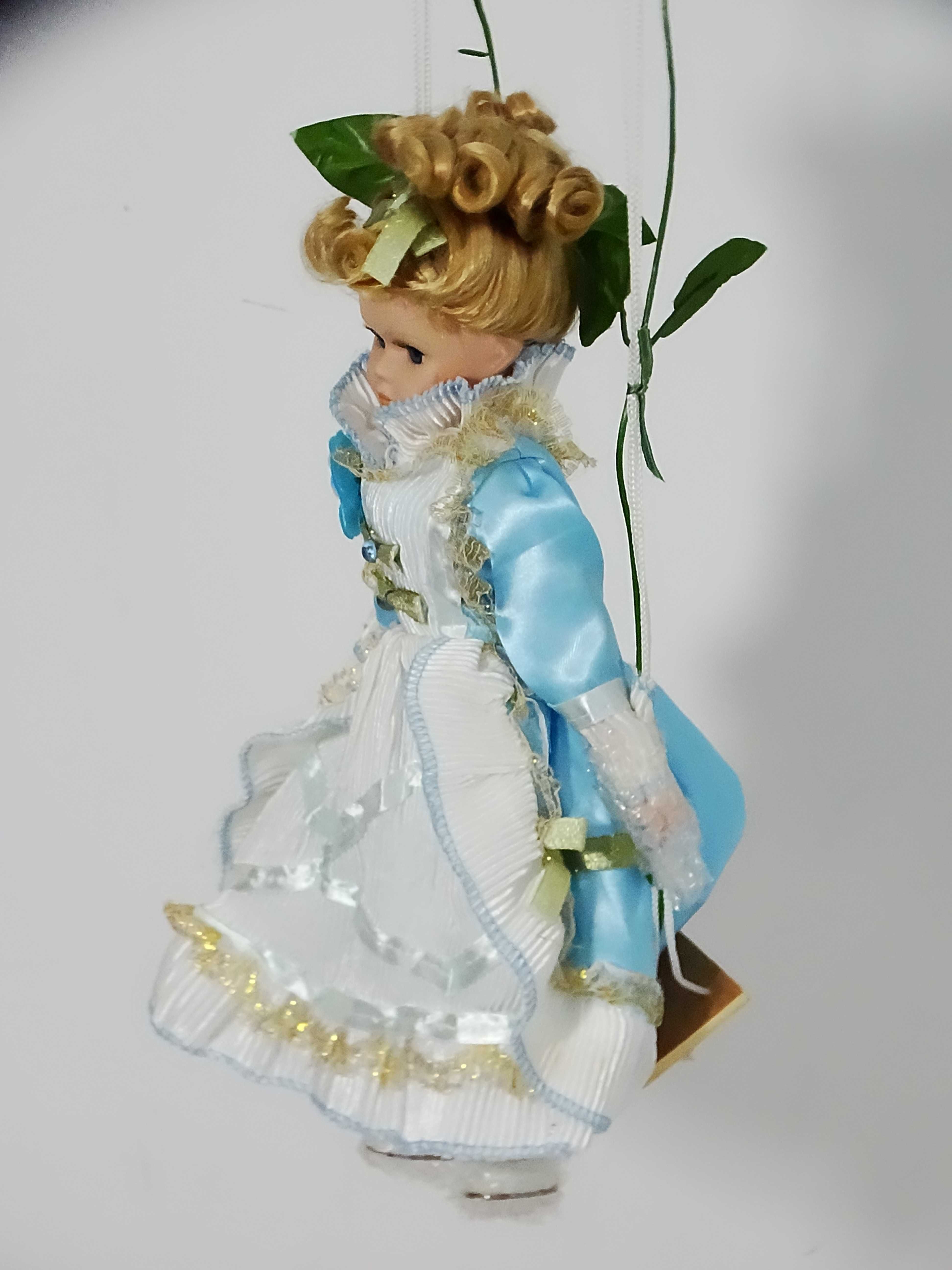 Porcelanowa laleczka dziewczynka na huśtawce