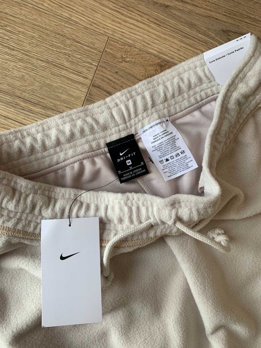 Damskie kremowe polarowe spodnie dresowe ze ściągaczami Nike M