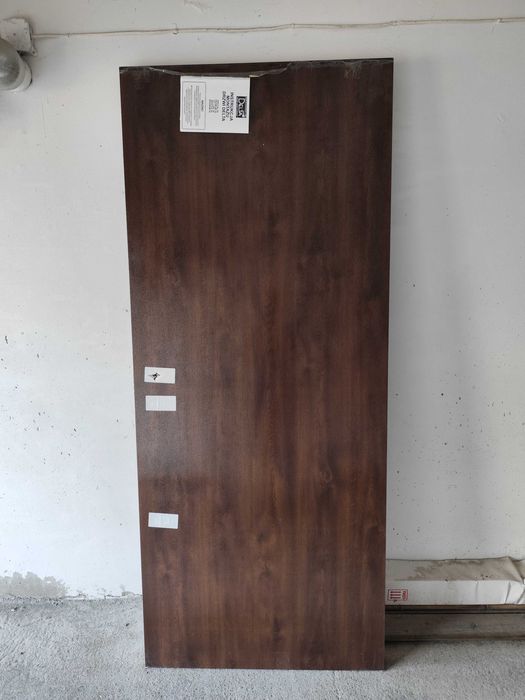 Nowe drzwi antywłamaniowe zewnętrzne do bloku z framugą i zamkami.