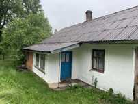 Земляний участок з будинком