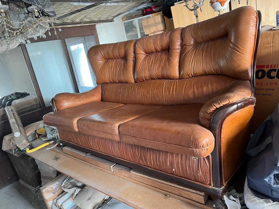 Sofa em pele, castanho com rebordo em madeira, usado