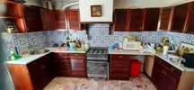 Cozinha com armários em madeira maciça e tampos em mármore