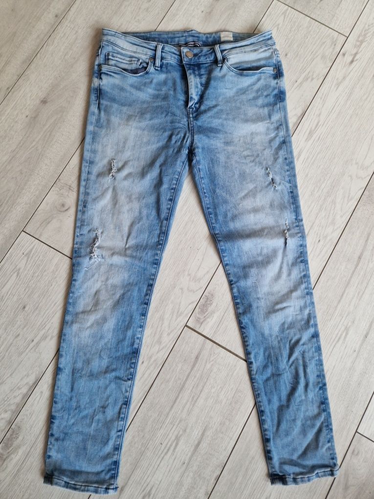 Damskie jeansy rurki tommy hilfiger elastyczne w32 L30 M/L z dziurami