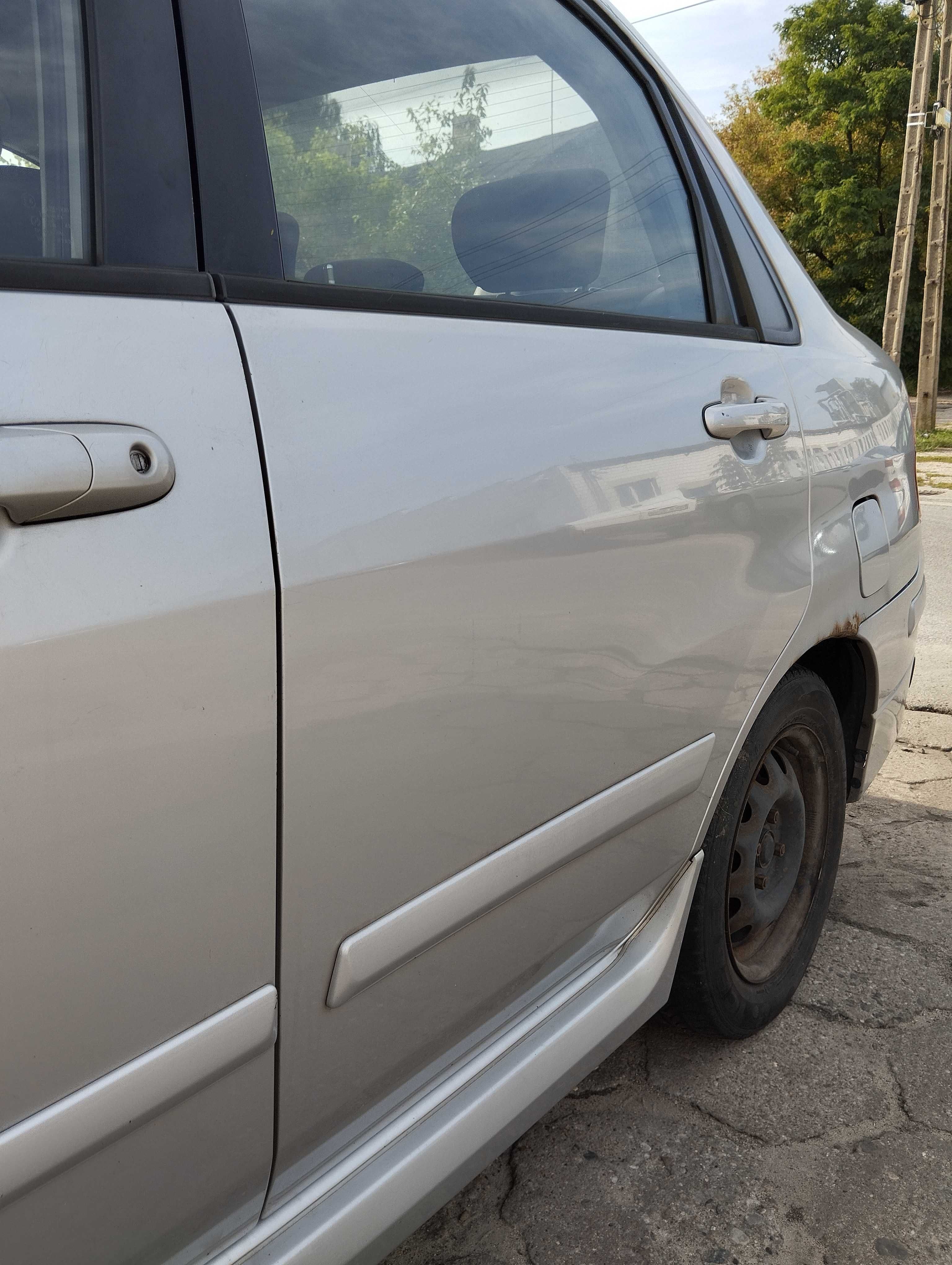Suzuki Liana 1.6i 4D Sedan 2004r.Drzwi tylne lewe.