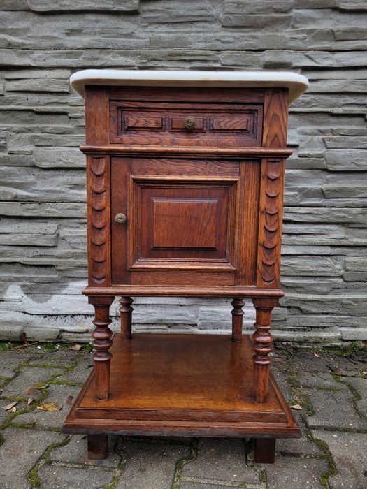 Zgrabna debowa szafka z szufladą.