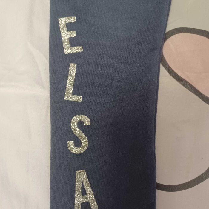 Spodnie dla dziewczynki z napisem ELSA rozmiar 116 cm Sinsay