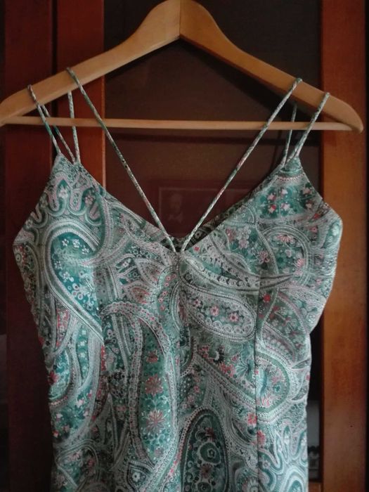 Macacão verde/salmão, da Formula Women.