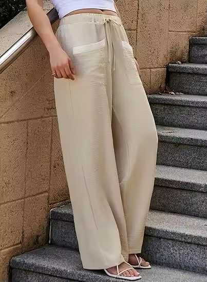 ... палацо брюки с широкими штанинами и контрастными карманами