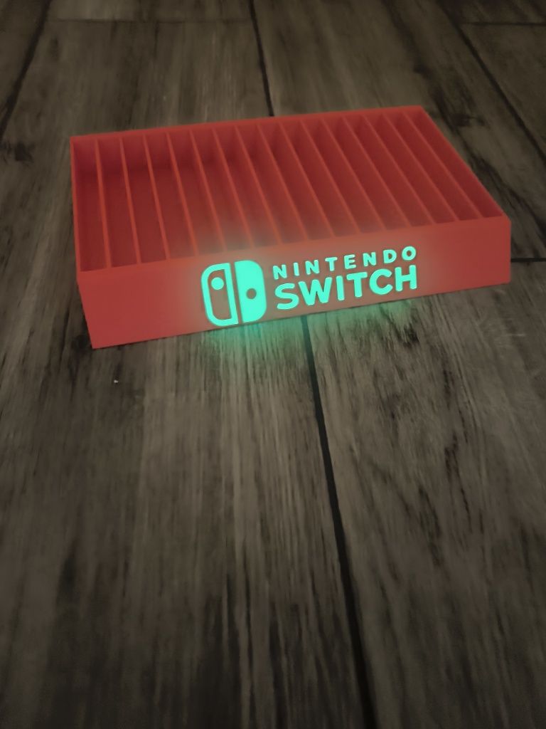 Stojak podstawka na gry Nintendo Switch napis fluorescencyjny