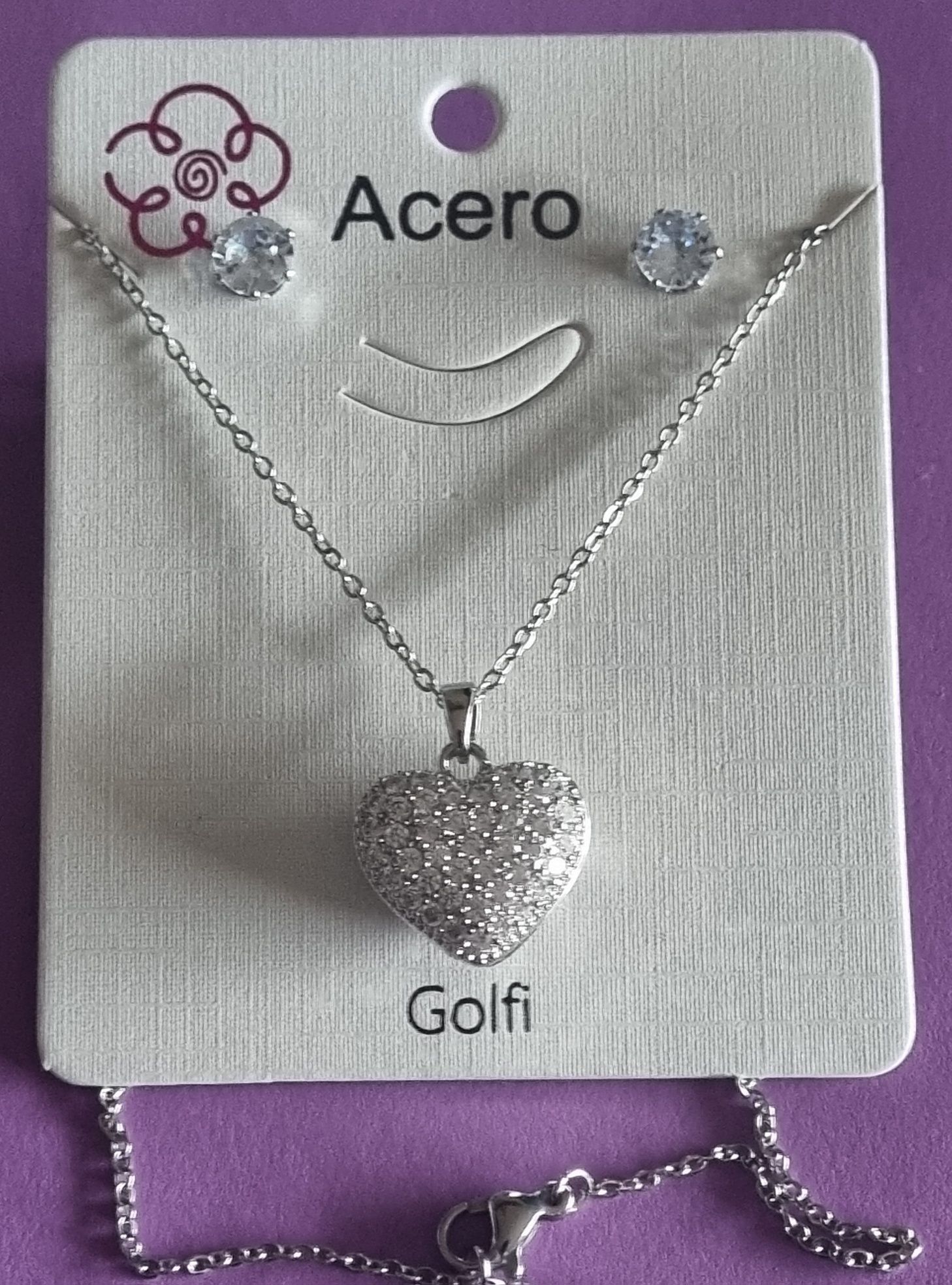 Conjunto prateado (colar e brincos), em aço, coração de zirconias.
