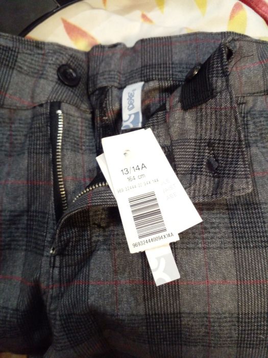 Нові  в клітинку брюки на 13-14років.164см...