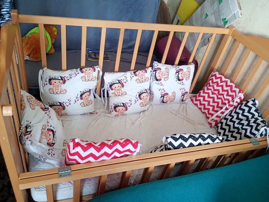 Ліжечко дитячє з подушками.