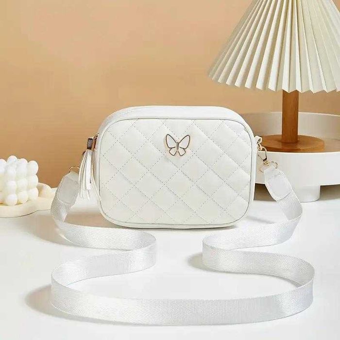 Сумка через плече, зручна з метеликом. Ремішок з написами та без