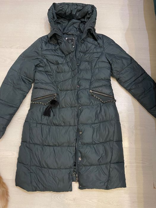 Теплий пуховик зеленого кольору.