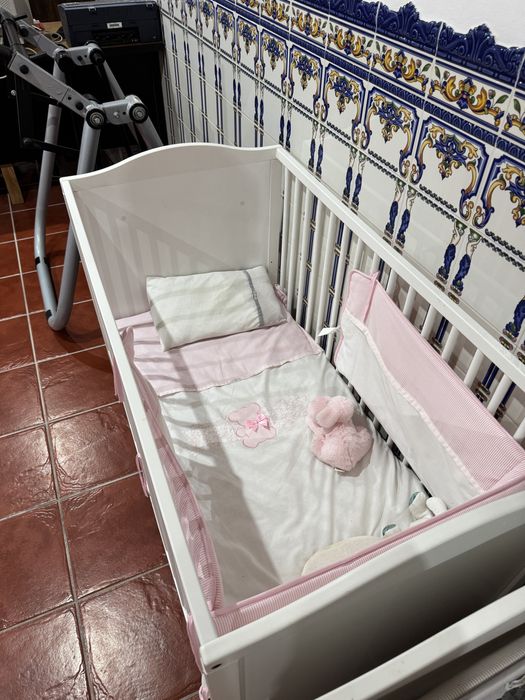 Dois berços estufados em cinza com colchão e roupa de cama