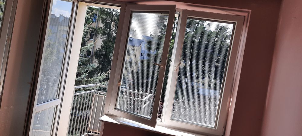 Okno balkonowe z roletami i parapetem