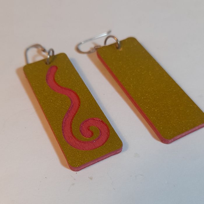 Wooden earrings with spiral design.