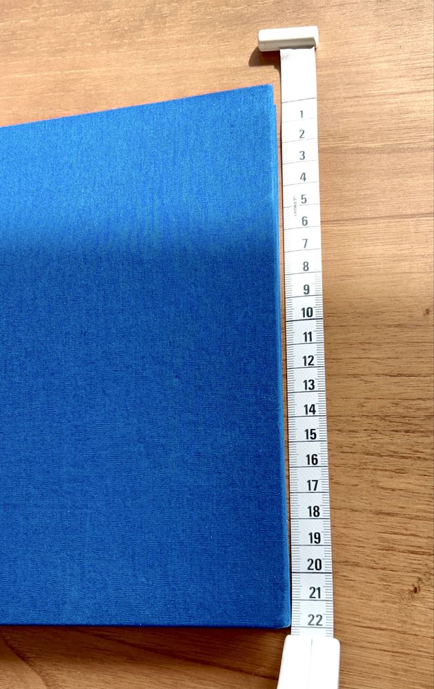 Caderno e capa dura forrada a tecido azul e com linhas