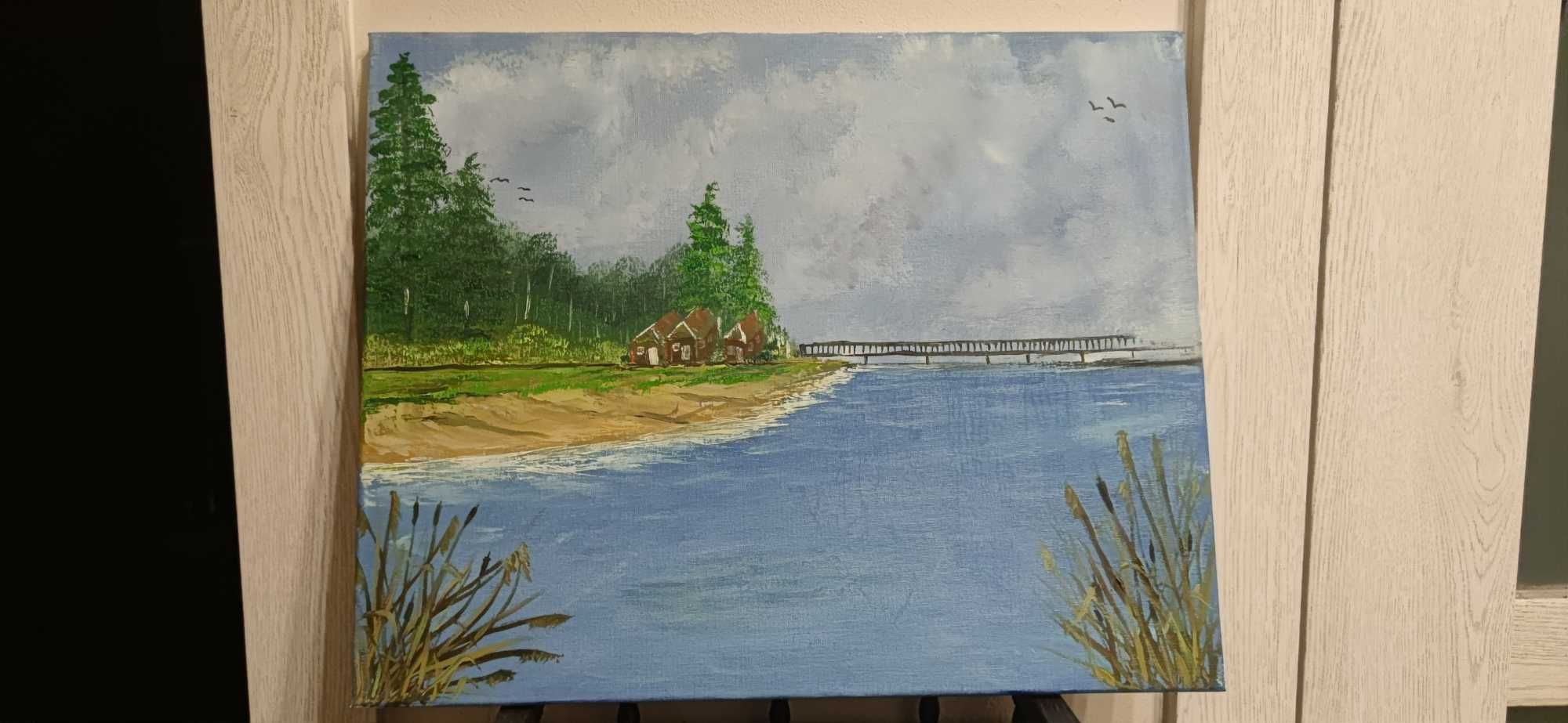 Obraz olejny plaży nad jeziorem.
