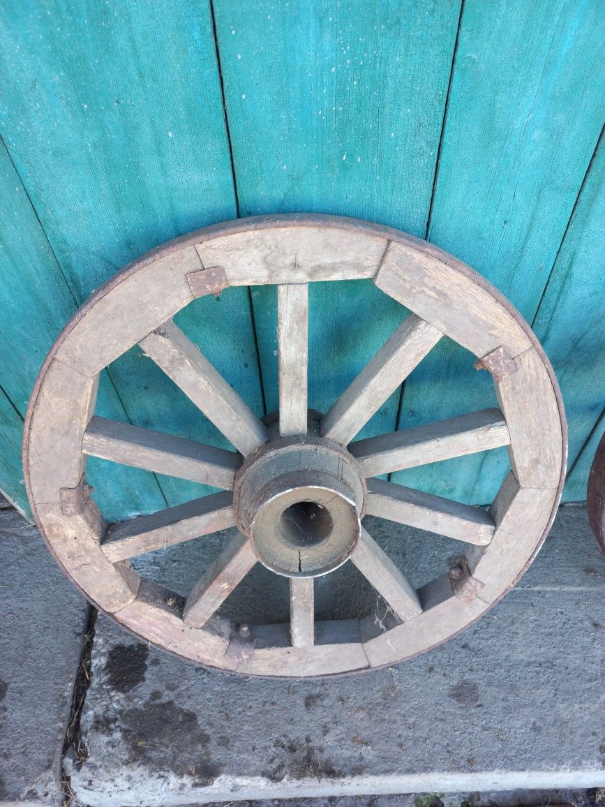 Дерев'яні колеса для воза та старовинна праска на вугілля.