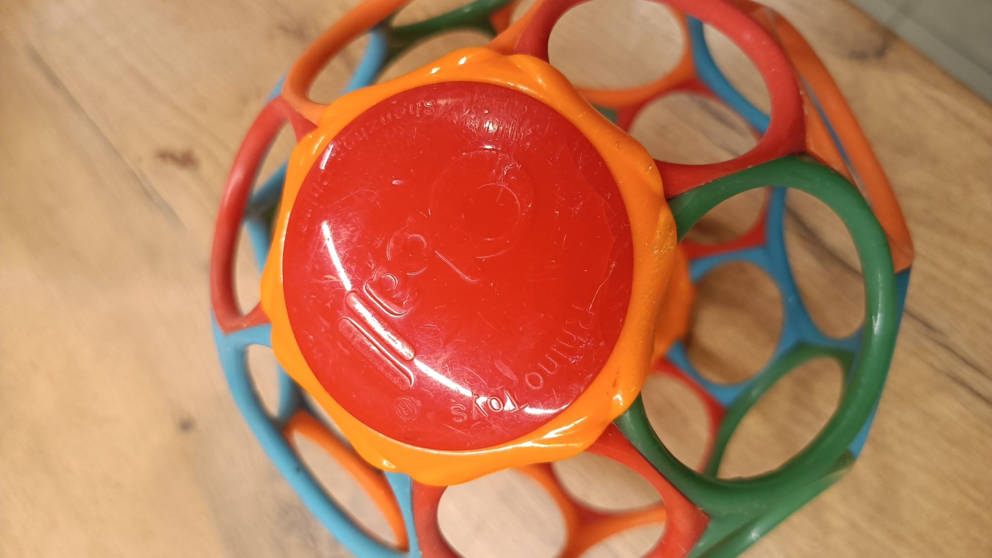 Piłka sensoryczna dla niemowląt Oball Rollin Rainstick Klepsydra 81030