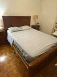 Cama de madeira de cor castanha com colchão usado