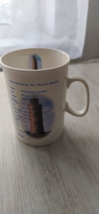 Porcelanowy kubek latarnia morska.