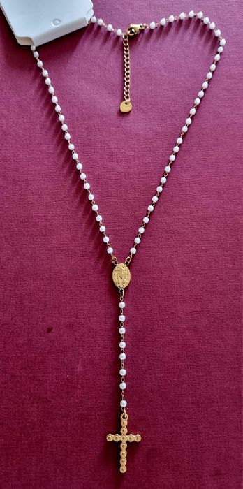 Colar dourado, em aço, em forma de terço com pequenas pérolas.