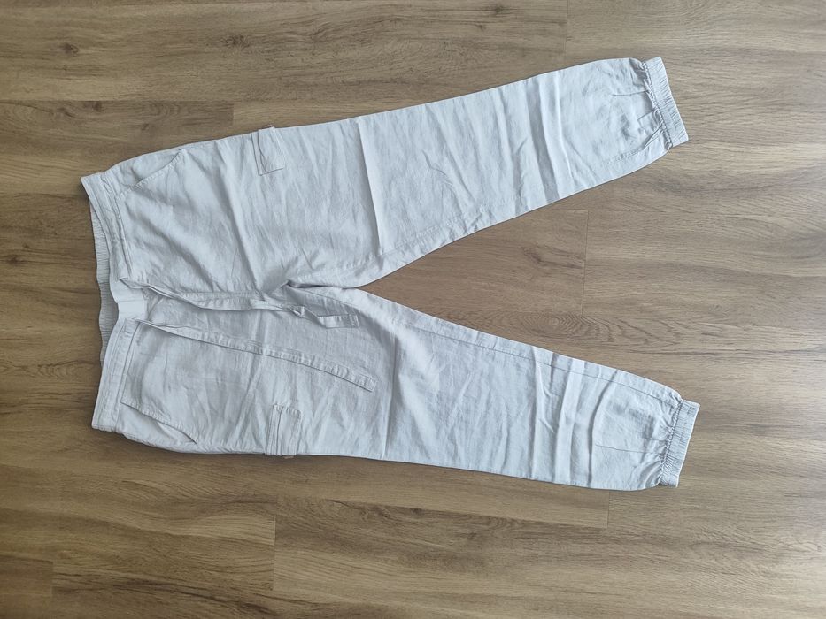 Beżowe/kremowe lniane spodnie joggery z wysokim stanem z gumką w pasie