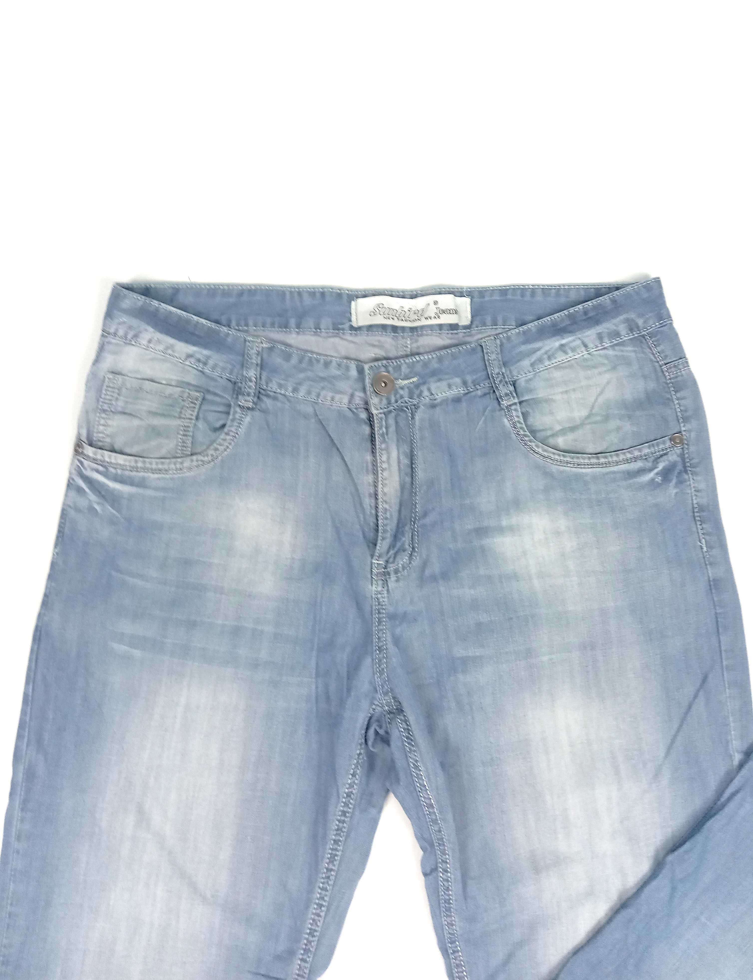 Jasno niebieskie cienkie jeansowe spodnie męskie z wybarwieniami r M/L