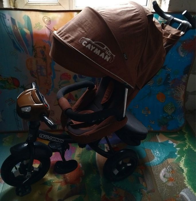 Продам детский музыкальный  велосипед-коляска Cayman.